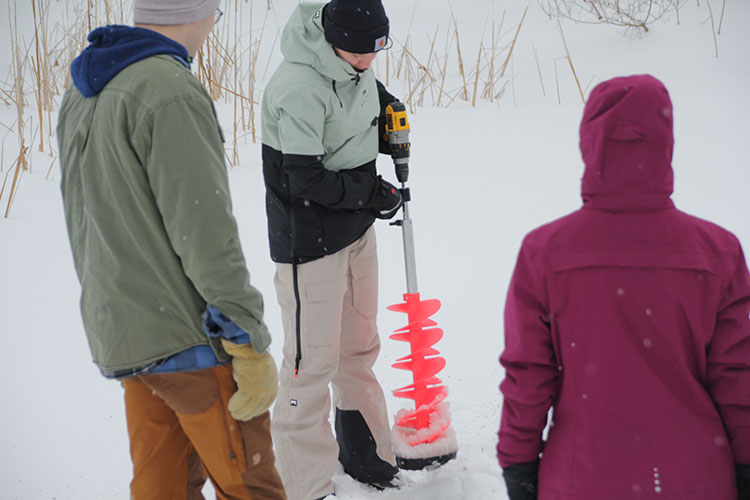 demonstrating a drill in snow