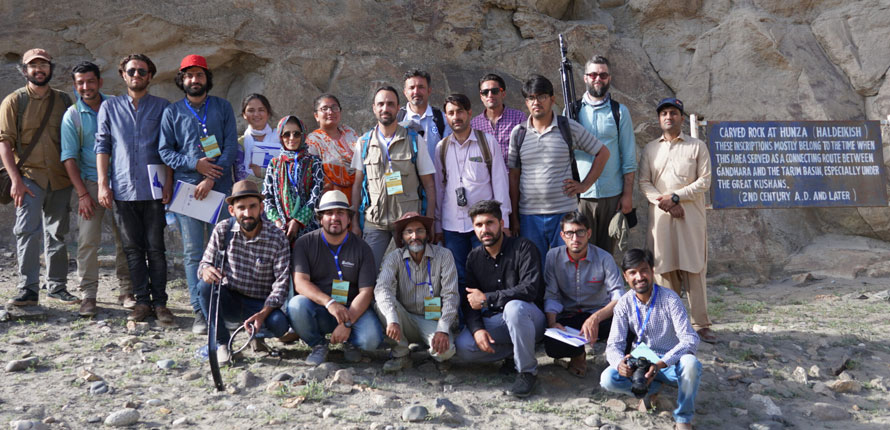researchers in front of rock wall